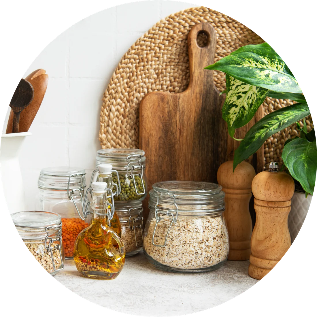 Pantry jars, grains, oil, wooden boards, and a leafy plant